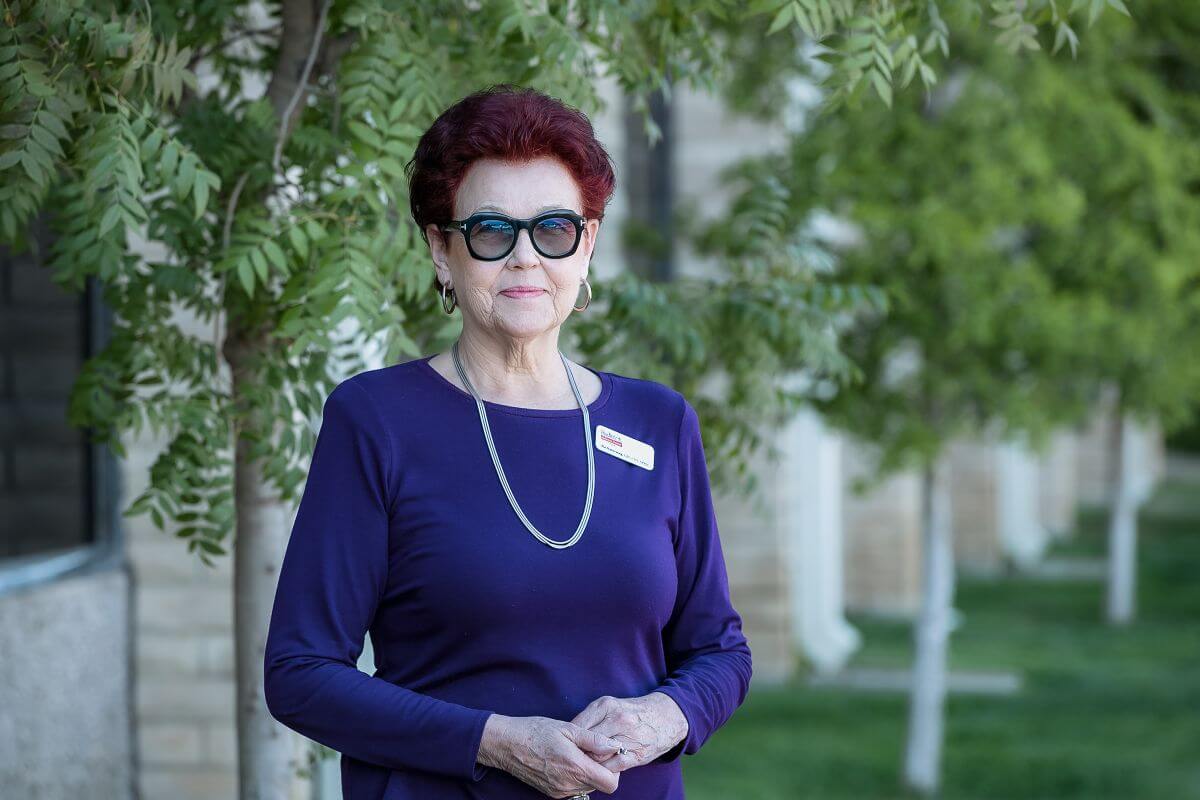 Dr.Pia stands outside her doctors office, Pediatric Wellness Center